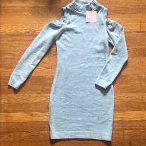 Grey sweater dress with sleeves cut out.